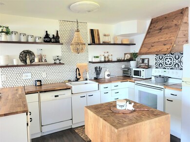 Kitchen with butcher block counters, island, decor