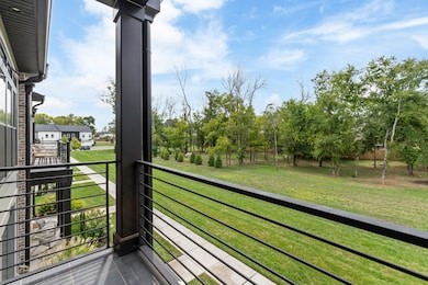 Primary bedroom balcony faces private wooded area