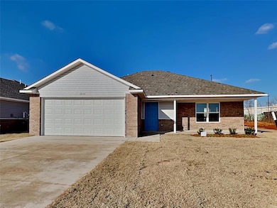 Ranch-style home with brick siding, concrete drive