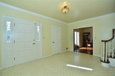 Entry is very roomy and has crown molding.