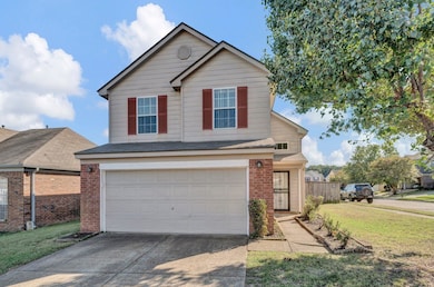 View of front property with a front lawn and a gar
