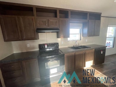 Kitchen featuring black appliances, healthy amount of natural light, dark wood finished floors, and under cabinet range hood