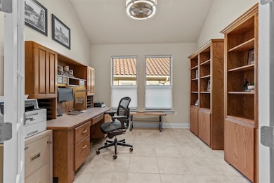 Office with vaulted ceiling and light tile patter