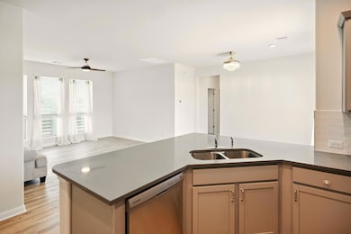 Kitchen with dishwasher, a sink, open floor plan,