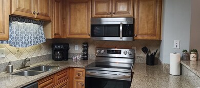Kitchen with backsplash, stainless steel appliance