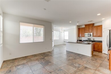 Kitchen featuring dark countertops, brown cabinets