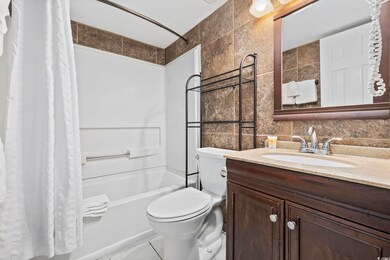 Full bathroom with tasteful backsplash, toilet, sh