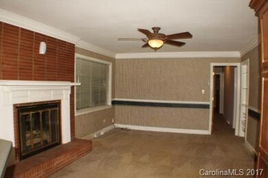 The den right off the kitchen has a gas fireplace, crown molding.