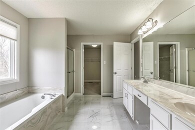 This stunning master bath has dual walk in closets