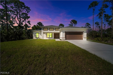 Prairie-style house with stucco siding, driveway,