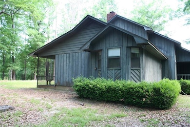 View of property exterior with a chimney, board an