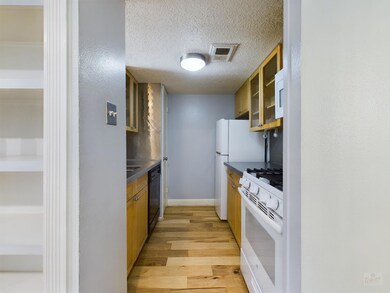 Kitchen with light wood-style floors, glass inser