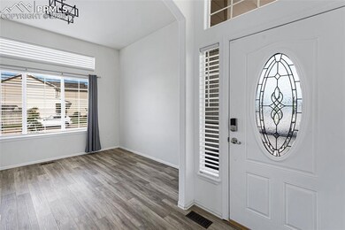 Entryway with wood finished floors and arched walkways