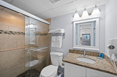 Bathroom featuring toilet, walk in shower, and van