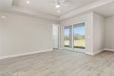 Unfurnished room with a raised ceiling, ceiling fa