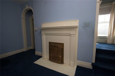 Ornate wood burning fireplace in Living room.