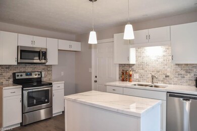Breathtaking kitchen with new white cabinets and s