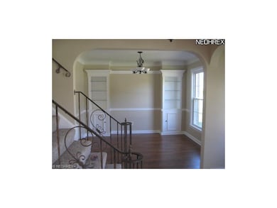 Pictured is the formal dining room and stairs lead