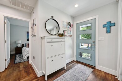 Foyer featuring baseboards, dark wood finished fl