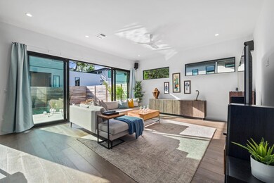 Living room with ceiling fan, wood finished floor