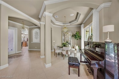 Dining room with a chandelier, light tile patterne