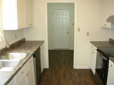 Kitchen: Features include laminate flooring for easy cleaning. a window for natural lighting and blinds for privacy. fresh paint, bright cabinets, a nice countertop and new decorative sink fixtures. The laundry room is to the far end and the closed door open to the rear deck and backyard. Appliances include the SST dishwasher and slide in stove.