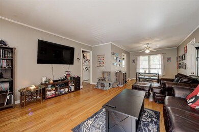 Living room with ornamental molding, ceiling fan, 