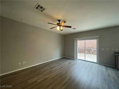 Spare room featuring baseboards, ceiling fan, visi