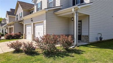 View of home's exterior featuring a garage, a yard