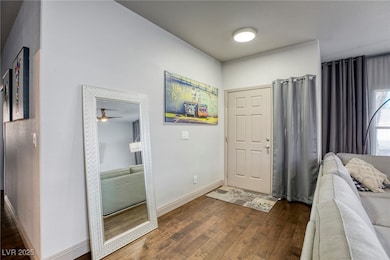 Foyer entrance featuring hardwood flooring and bas