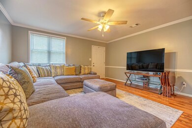 Living room featuring crown molding, hardwood / wo