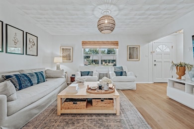 Living room featuring light wood-style flooring and baseboards