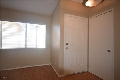 Entryway with baseboards and wood finished floors