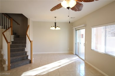 Foyer with light tile patterned flooring, a chande