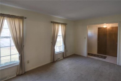Large formal living room with hardwoods under the 
