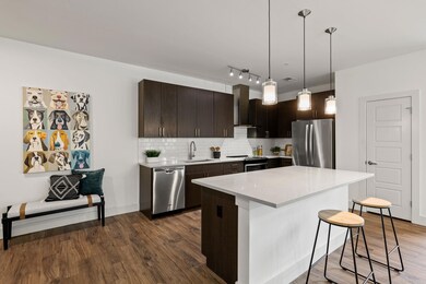 Kitchen featuring a breakfast bar area, a sink, d