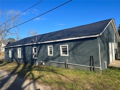 View of side of home with a lawn
