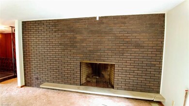 Full wall brick fireplace with floating hearth anc