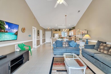 Tiled living room with ceiling fan with notable ch