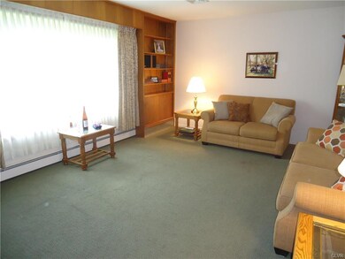Living Room has hardwood flooring under the carpet