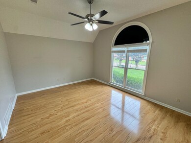 Spare room with ceiling fan, a textured ceiling, l
