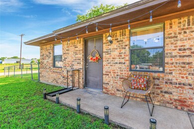 Doorway to property featuring a lawn