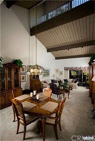 DINING AREA WITH VAULTED CEILINGS AND SKYLIGHTS