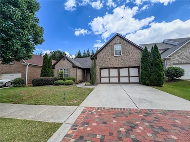 View of front of house featuring brick siding, dri