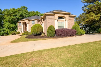 View of front of home featuring driveway, brick si