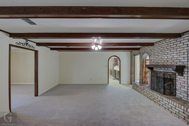 Family/  living room with beamed ceiling, carpet, 