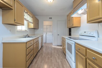 Kitchen with light countertops, electric range, se