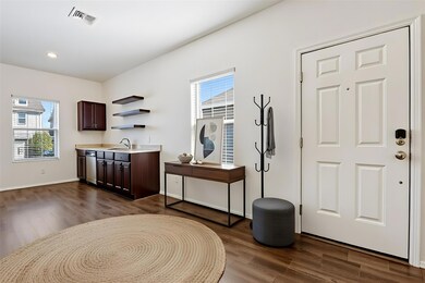 Interior entry and kitchen, virtually staged