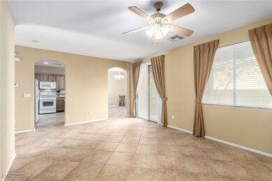 Empty room with visible vents, baseboards, arched