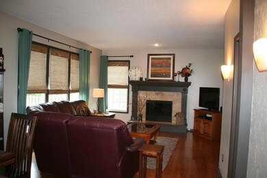 Gas log fireplace and wall sconces enhance the gre